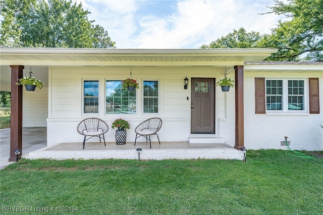 1723 N 52nd St, Fort Smith, AR 72904 - property entrance with a porch, a lawn, and a carport
