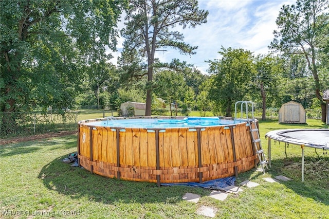 1723 N 52nd St, Fort Smith, AR 72904 - swimming pool with a storage shed, a trampoline, and view of scattered trees