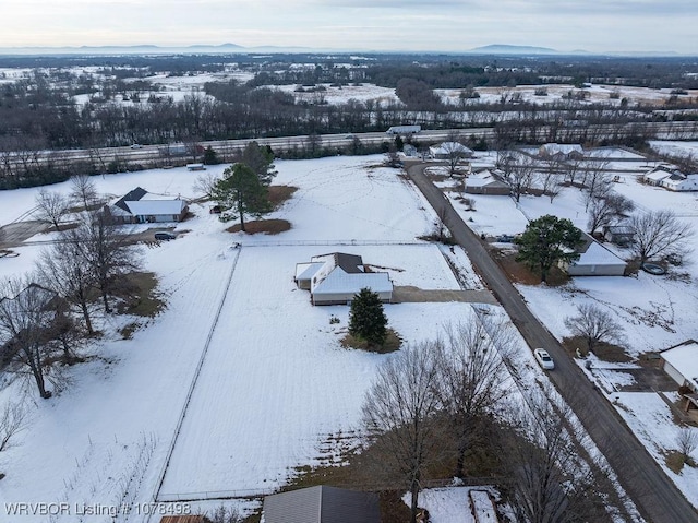 snowy aerial view with a mountain view