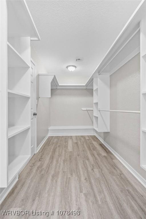 spacious closet featuring light wood-type flooring