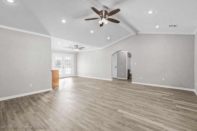 unfurnished living room featuring hardwood / wood-style floors, french doors, lofted ceiling with beams, ceiling fan, and crown molding