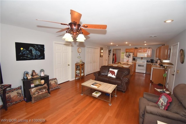 living room featuring ceiling fan, wood finished floors, and recessed lighting