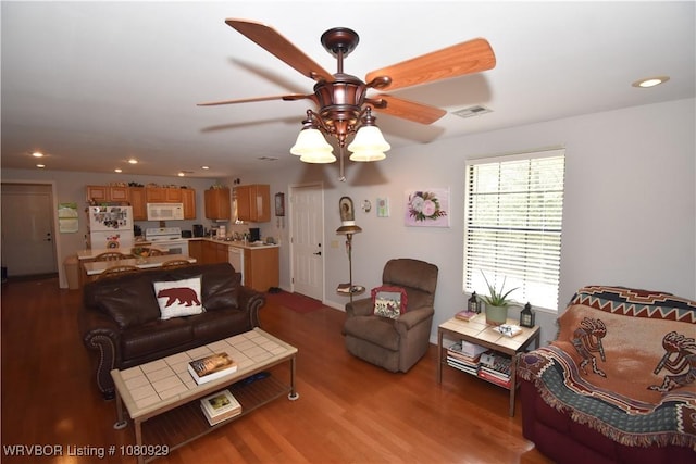 living area with a ceiling fan, wood finished floors, and recessed lighting