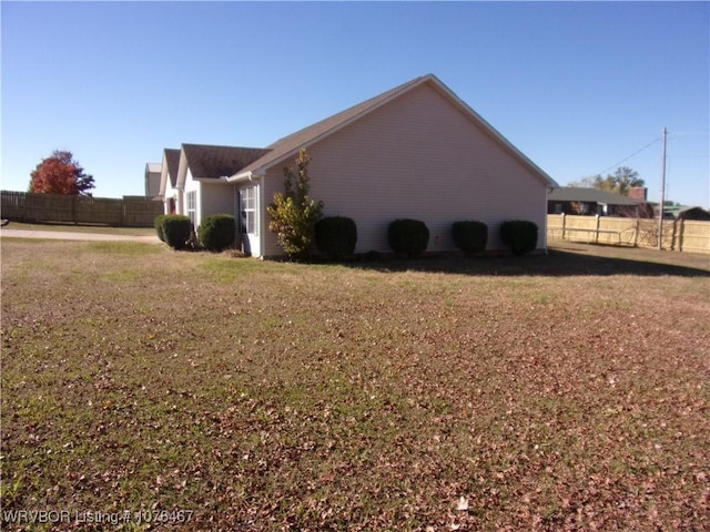 view of side of property featuring a yard