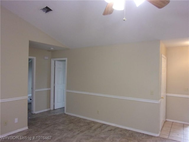 spare room featuring tile patterned floors, ceiling fan, and vaulted ceiling