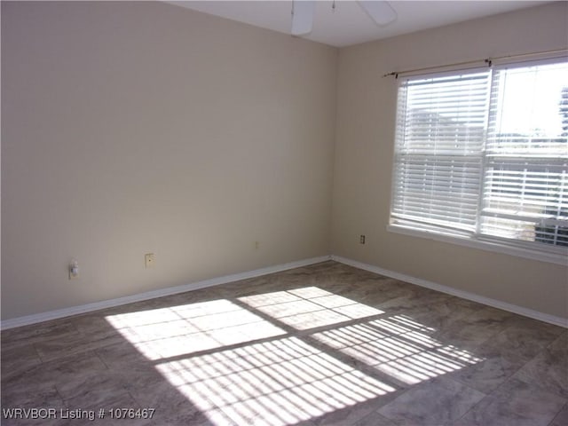 unfurnished room with ceiling fan