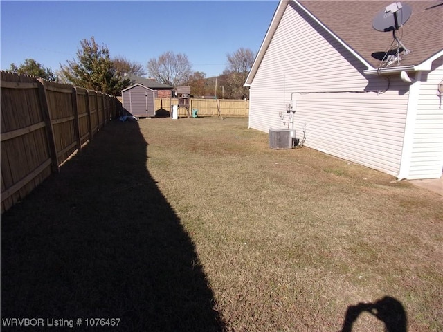 view of yard with a playground, a shed, and central air condition unit