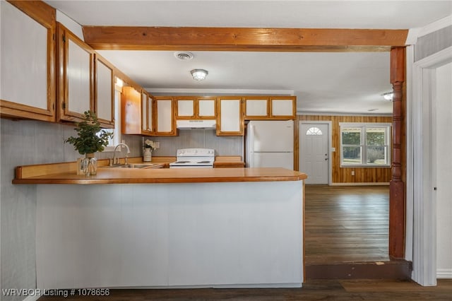 kitchen featuring beam ceiling, sink, white appliances, and kitchen peninsula