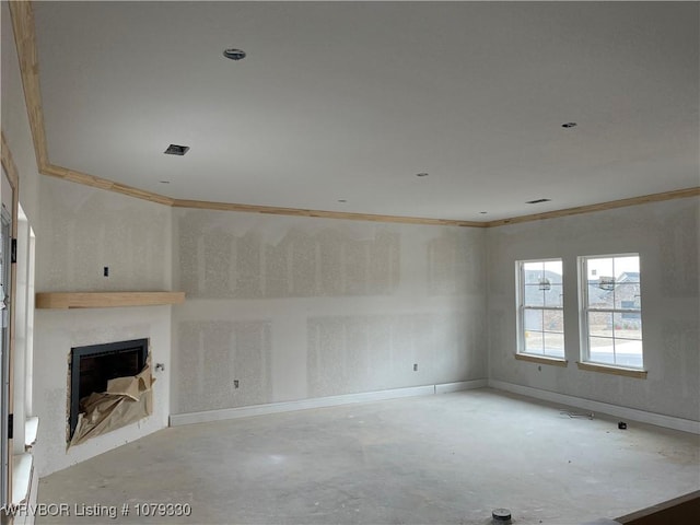 unfurnished living room featuring ornamental molding, unfinished concrete flooring, a fireplace, and baseboards