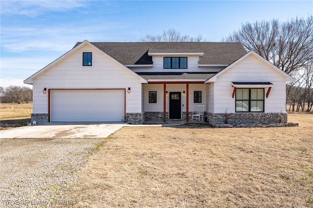 modern inspired farmhouse with driveway, a garage, a front lawn, and brick siding