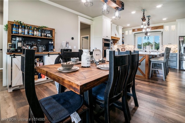 dining area featuring dark hardwood / wood-style floors and ornamental molding