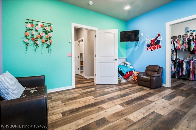 sitting room with dark hardwood / wood-style flooring