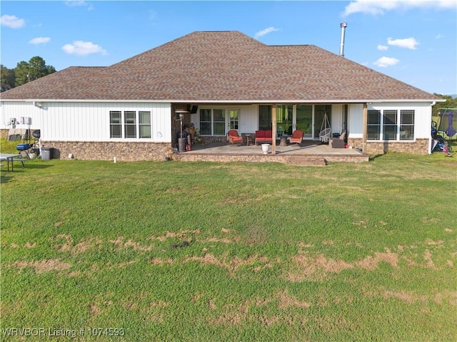 rear view of property with a lawn and a patio area