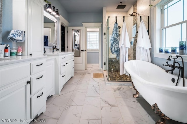 bathroom featuring vanity, separate shower and tub, and a wealth of natural light