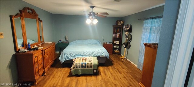 bedroom with light hardwood / wood-style flooring and ceiling fan