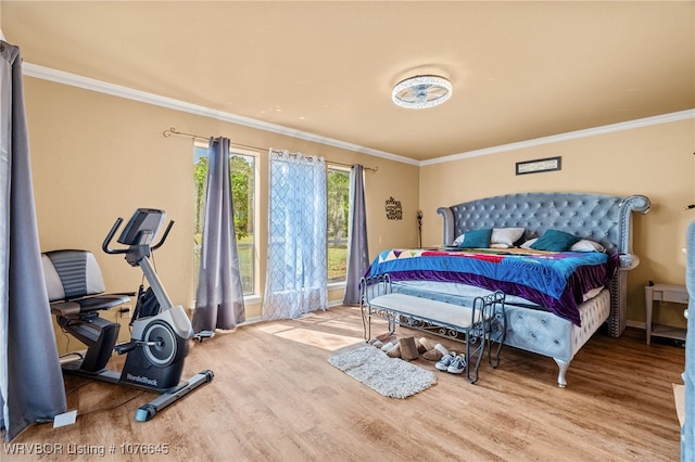 bedroom featuring light hardwood / wood-style flooring and ornamental molding