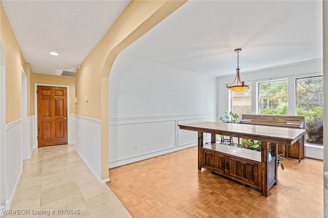 hall with a textured ceiling and light parquet floors