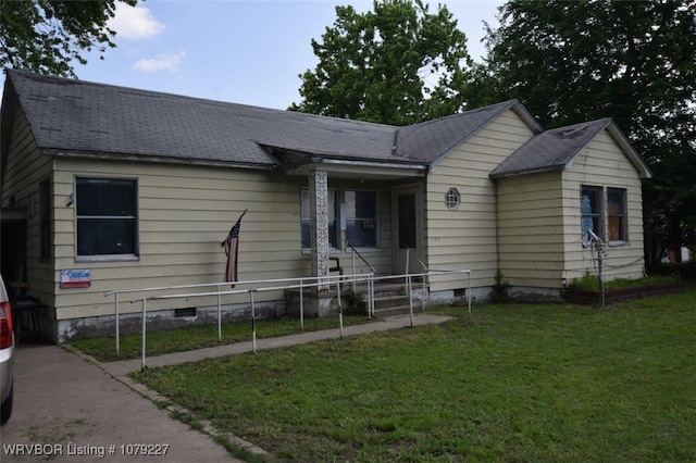 ranch-style house with a front yard, crawl space, roof with shingles, and fence