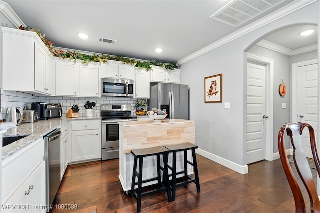 1026 Snow Goose Way, Barling, AR 72923 - kitchen with backsplash, arched walkways, appliances with stainless steel finishes, and visible vents