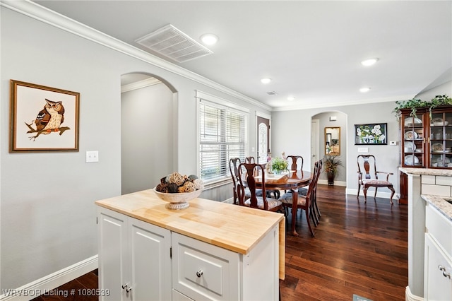 1026 Snow Goose Way, Barling, AR 72923 - kitchen with arched walkways, wood counters, visible vents, and ornamental molding