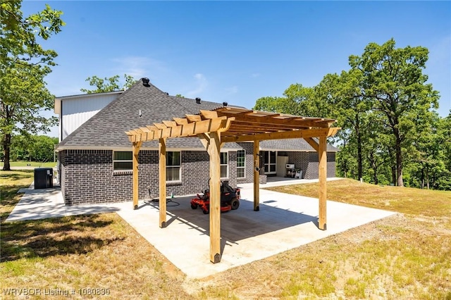 view of patio / terrace with central air condition unit and a pergola