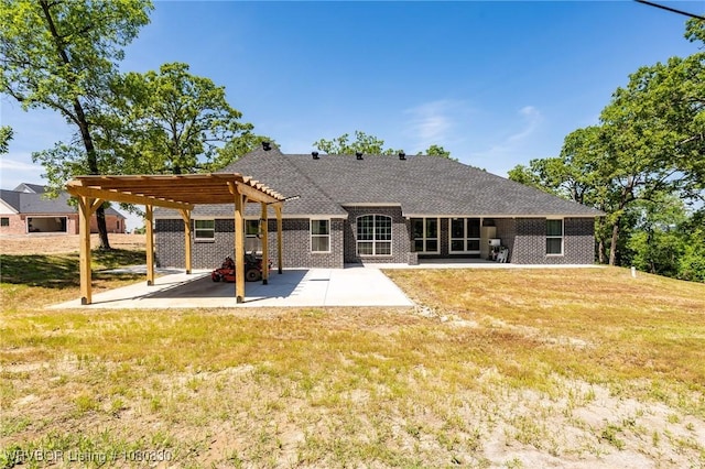 rear view of property featuring a lawn, a patio, a pergola, and brick siding