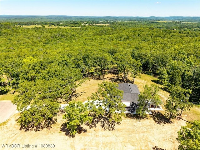 birds eye view of property featuring a view of trees