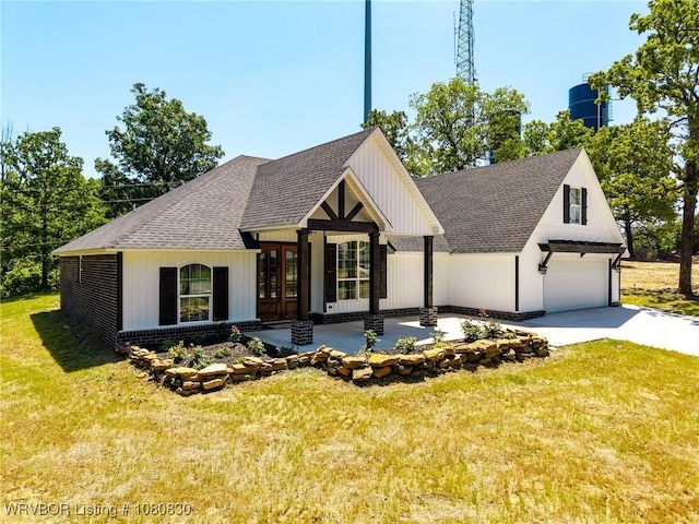modern inspired farmhouse featuring roof with shingles, a garage, a front lawn, and french doors