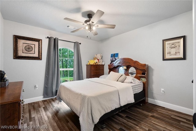 bedroom with a ceiling fan, baseboards, dark wood-style floors, and visible vents