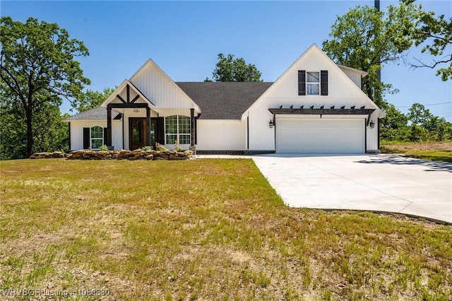 modern inspired farmhouse featuring concrete driveway and a front lawn