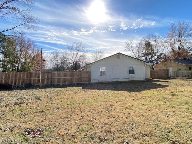 view of home's exterior featuring a yard and fence