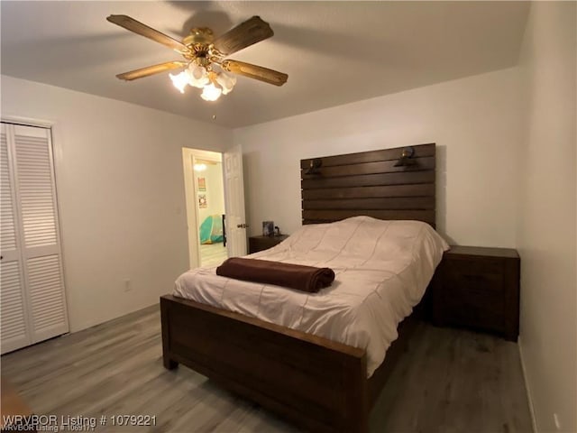 bedroom featuring ceiling fan, a closet, and wood finished floors