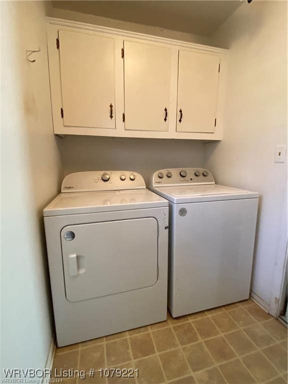 laundry area with cabinet space and washing machine and clothes dryer