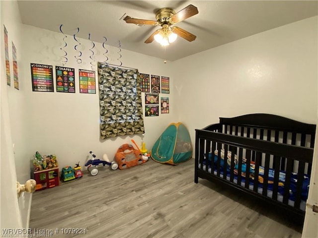 bedroom with ceiling fan and wood finished floors