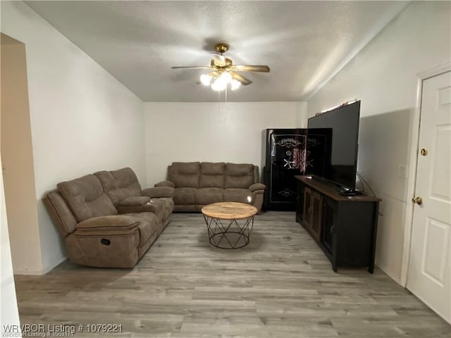 living area featuring a ceiling fan and light wood-style flooring