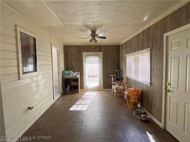 interior space with ceiling fan