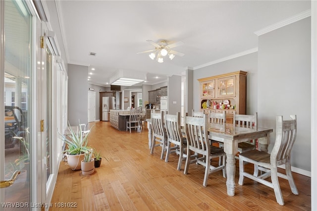 25 Shibley Rd, Van Buren, AR 72956 - dining area with ceiling fan, light wood-style floors, crown molding, baseboards, and healthy amount of natural light