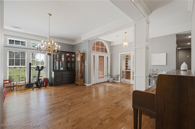 25 Shibley Rd, Van Buren, AR 72956 - entrance foyer with ornamental molding, a chandelier, light wood-style flooring, and baseboards