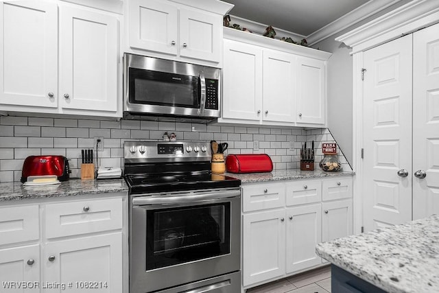 1024 Mourning Dove Way, Barling, AR 72923 - kitchen with appliances with stainless steel finishes, crown molding, white cabinets, tasteful backsplash, and light stone counters
