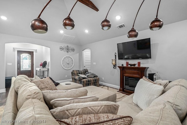1024 Mourning Dove Way, Barling, AR 72923 - living area featuring arched walkways, vaulted ceiling, recessed lighting, wood finished floors, and a glass covered fireplace