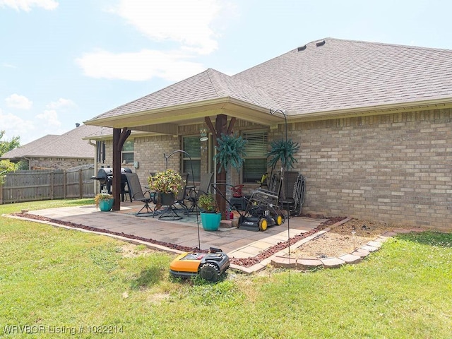 1024 Mourning Dove Way, Barling, AR 72923 - rear view of house with a shingled roof, a patio, and brick siding