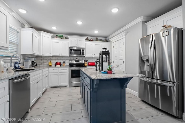 1024 Mourning Dove Way, Barling, AR 72923 - kitchen featuring stainless steel appliances, backsplash, white cabinets, ornamental molding, and a center island