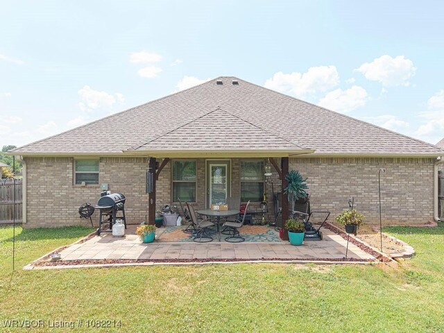 1024 Mourning Dove Way, Barling, AR 72923 - back of property featuring a shingled roof, a patio, and brick siding