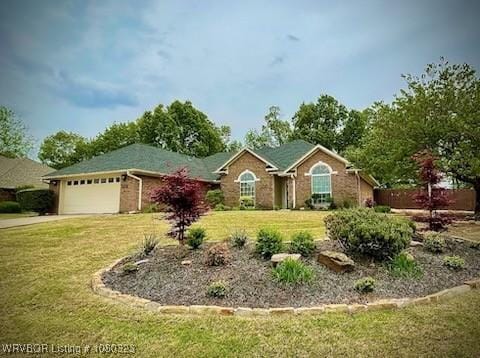 ranch-style house featuring a front yard, driveway, and a garage