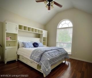 bedroom featuring dark wood-style floors, a ceiling fan, lofted ceiling, and baseboards