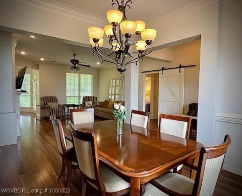 dining area with a barn door, crown molding, a chandelier, and dark wood-style floors