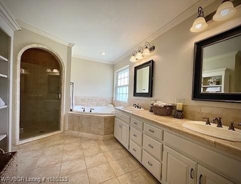 full bathroom with crown molding, a bath, a stall shower, and a sink