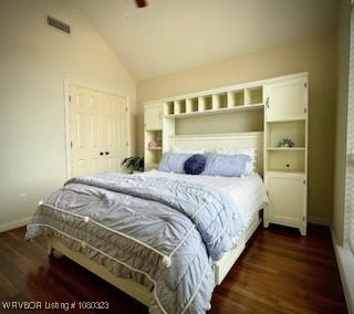 bedroom featuring vaulted ceiling, visible vents, dark wood-style floors, and baseboards