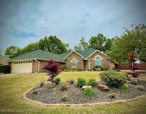 ranch-style home featuring fence, driveway, a front yard, and an attached garage