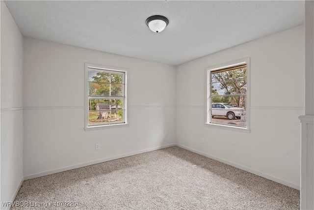 unfurnished room with a wealth of natural light and baseboards